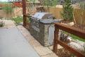 patio covered by a pergola and outdoor natural gas grill